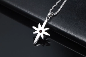 Macro detail of punk style octagonal star necklace pendant with red ruby inlay