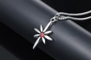 Macro shot of punk style stainless steel star pendant with central red ruby zircon stone