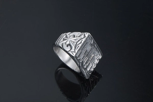 Macro shot of silver titanium steel ring with octagonal star and vintage engravings