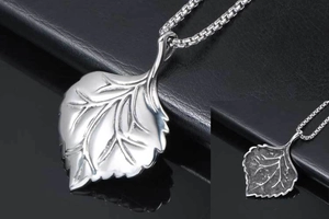 Detailed view of leaf pendant showing intricate vein texture and box chain