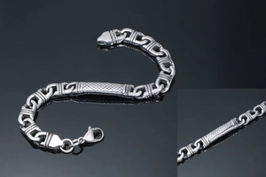 Close-up of men's chunky stainless steel totem bracelet with lobster clasp and textured detail