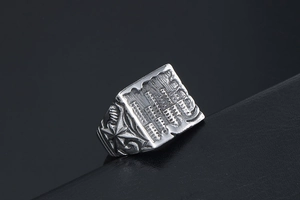 Detailed macro shot of vintage signet ring with geometric city light relief patterns