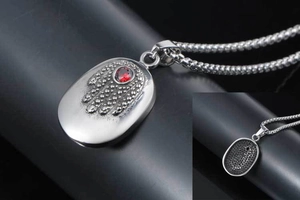 Detailed close-up of Hamsa Hand pendant with red ruby center and textured honeycomb back