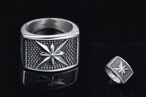 Macro shot of punk style stainless steel ring with 8-point star and textured detail