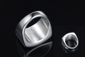 Macro detail of men's punk star ring showing polished surface and brushed inner finish