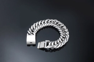 Macro detail of silver titanium steel Cuban link bracelet with a square clasp closure