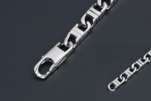 Detail of silver rectangular link chain bracelet with textured finish and lobster clasp