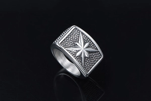 Macro shot of a men's punk star signet ring in vintage stainless steel with bead texture