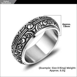 Detail view of 7.8mm wide vintage embossed rotating titanium steel ring with totem patterns
