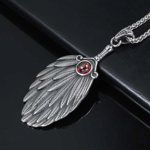 Vintage Chinese feather fan pendant necklace with red gemstone and detailed silver texture