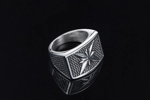 Macro shot of punk star signet ring in silver titanium steel with textured grain details