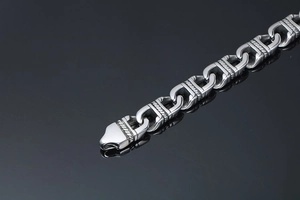 Macro shot of silver stainless steel chain with spiral texture and U-shaped links