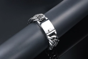 Close-up of polished silver titanium steel Cuban chain bracelet with rectangle clasp