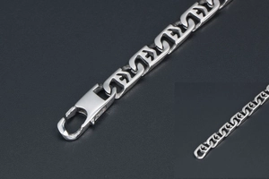 Macro detail of geometric titanium steel chain links with large lobster clasp closure