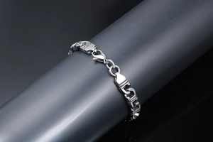 Close-up of punk style stainless steel totem chain bracelet with robust links and lobster clasp