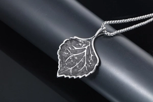 Macro detail of leaf pendant with realistic veins and vintage silver finish
