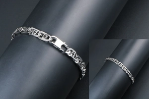 Detail of industrial style titanium steel flat anchor chain bracelet on a display stand