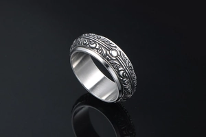 Macro detail of retro stainless steel ring with intricate embossed vintage pattern