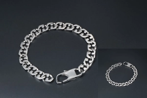 Detailed view of high-polished silver curb chain bracelet with large lobster clasp