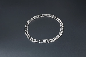 Close-up of a silver titanium steel punk bracelet featuring geometric hollow link patterns