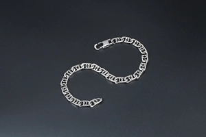 Detail shot of silver stainless steel chain bracelet with geometric hollow links and lobster clasp