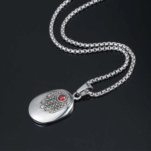 Vintage steel Hamsa Hand pendant necklace with red gemstone on a dark box chain