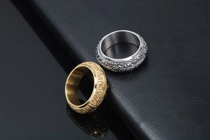 Macro shot of two vintage steel rings with baroque scrollwork engraving in gold and silver