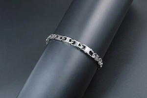 Macro view of silver H-link chain bracelet with secure lobster clasp for men