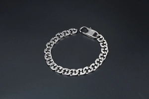 Macro detail of geometric links and large lobster clasp on titanium steel chain bracelet