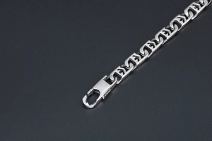 Detail of silver titanium steel chain with unique geometric links and lobster clasp