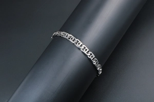 Detailed close-up of a silver titanium steel anchor link chain bracelet on a black stand
