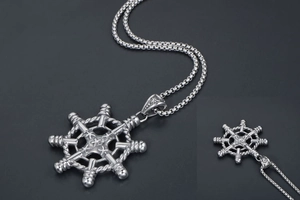 Macro shot of retro nautical helm pendant with rope texture and stainless steel box chain