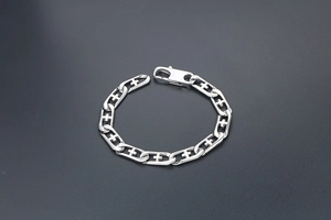 Detail of silver titanium steel chain bracelet with hollow cross pattern and lobster clasp