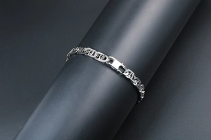 Close-up of silver titanium steel chain bracelet with geometric hollow links and clasp