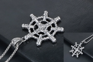 Detailed close-up of silver rudder pendant with star relief and box chain for men