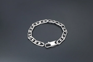Detail of silver titanium steel chain bracelet with hollow cross links and lobster clasp