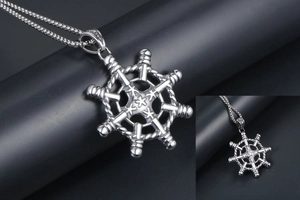 Macro detail of silver ship steering wheel pendant and stainless steel chain