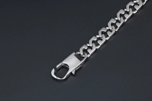 Close-up of silver titanium steel chain link bracelet featuring a large lobster clasp