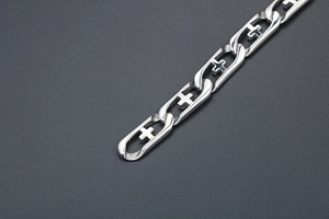 Detailed macro view of polished titanium steel bracelet with hollow cross link design