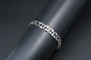 Detailed view of polished silver titanium steel geometric interlocking link bracelet