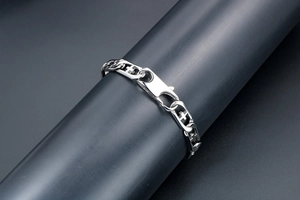 Detail of titanium steel cross link bracelet with large lobster clasp on display