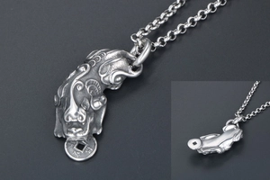 Close-up of vintage titanium steel Pixiu pendant with detailed texture and ancient coins