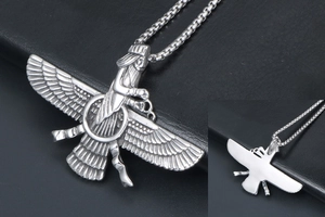 Macro detail of silver Faravahar pendant with double wings on black leather background