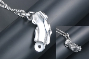 Close-up of vintage titanium steel Pi Xiu pendant with detailed ancient coin engraving