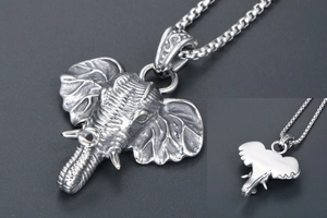 Detail of vintage silver elephant pendant with box chain showing front and back view