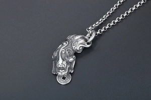 Close-up of vintage titanium steel Pixiu pendant with antique finish and coin details