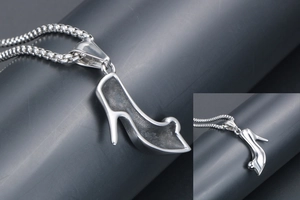 Detailed close-up of a silver high heel pendant necklace with a sleek box chain style