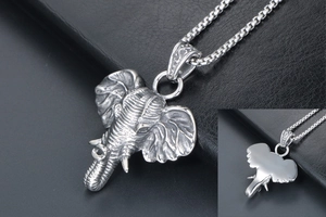 Macro detail of vintage silver elephant pendant showing intricate carved trunk and ivory texture