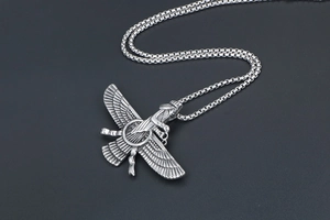 Close-up of silver Faravahar wing pendant with detailed texture on box chain