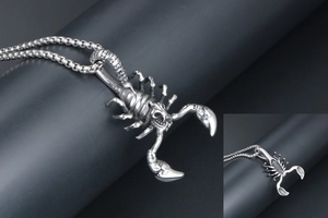 Detailed close-up of retro scorpion pendant with stainless steel box chain necklace